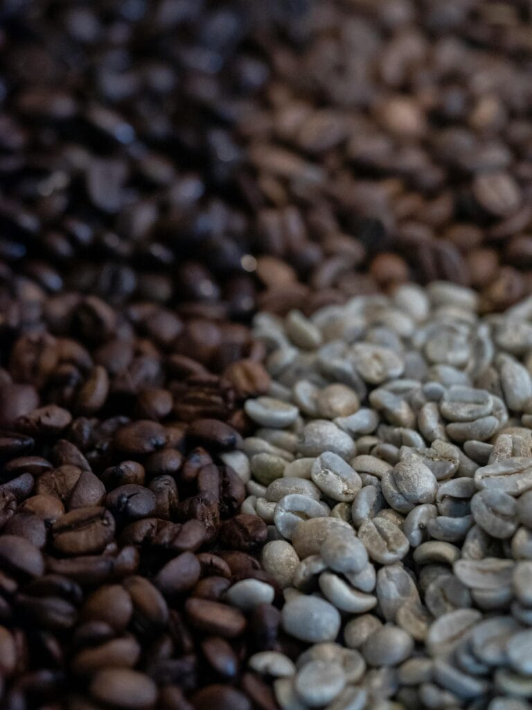 Close-up of coffee beans in various roast levels showcasing rich textures. Perfect for coffee lovers.